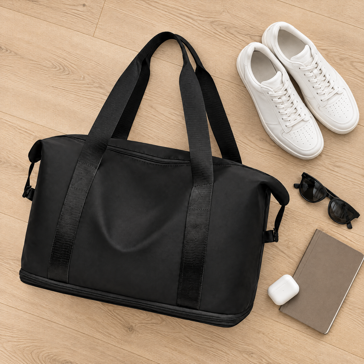 Nomadly duffel from above with sneakers and sunglasses