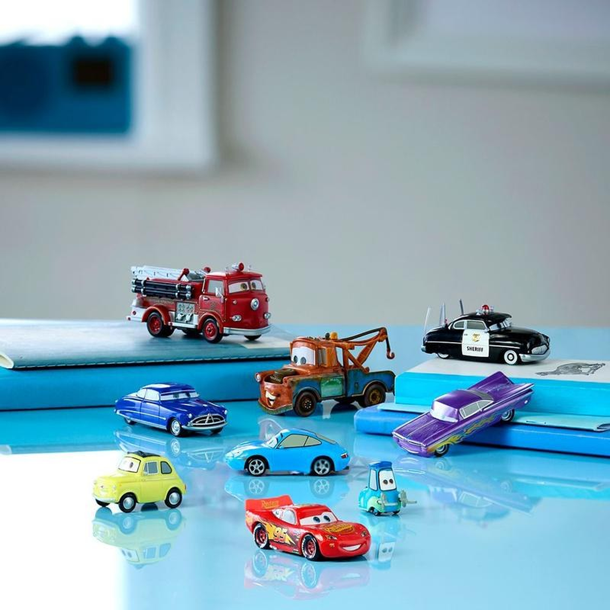 TurboTrack cars on a shelf beside books